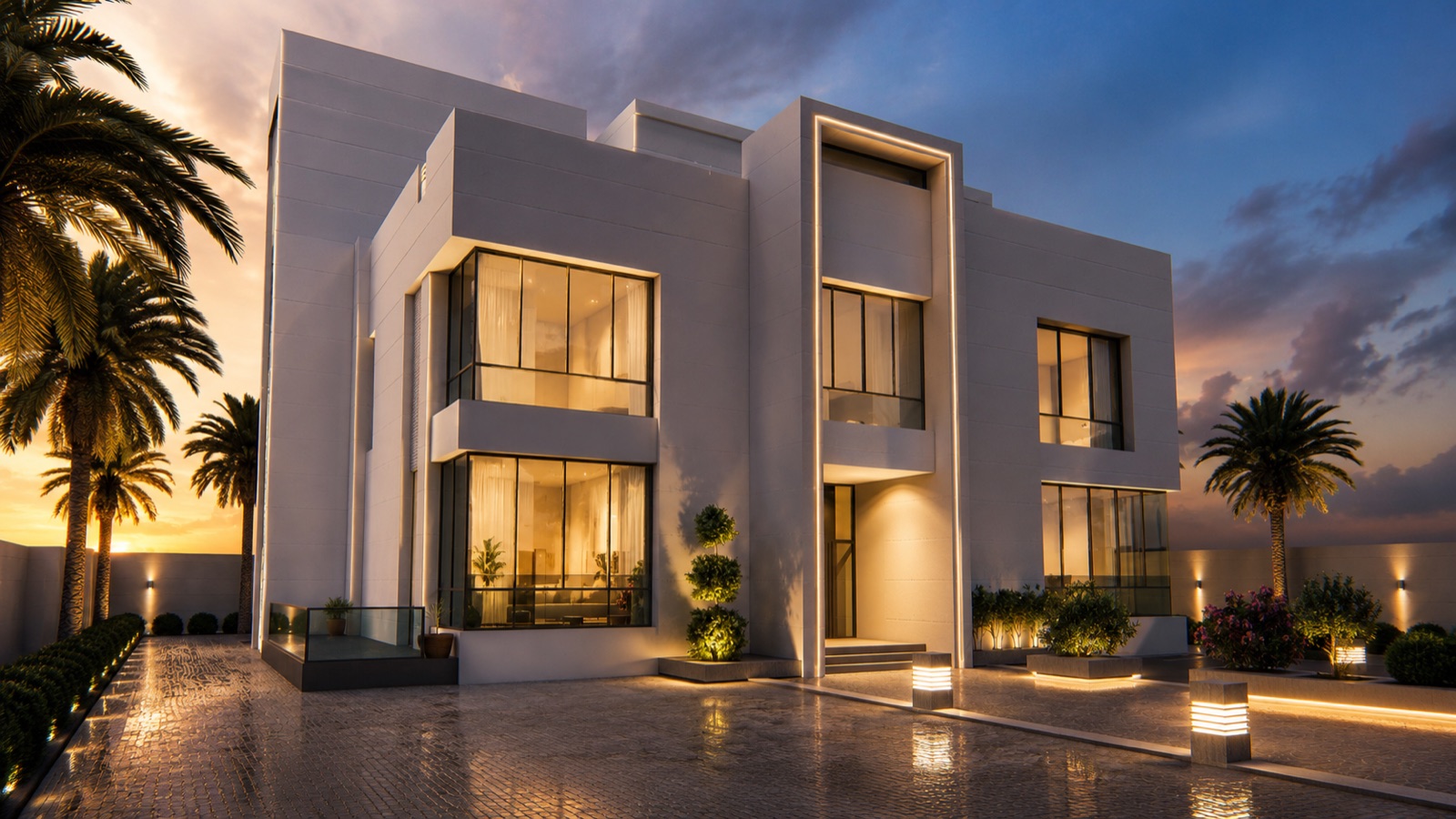 AAMH Villa, a modern white villa with glass façades, warmly lit at dusk